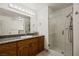 Bathroom featuring a large mirror, glass-enclosed shower, and oak cabinets at 1470 St Joseph St, Overton, NV 89040