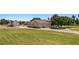 House featuring an attached garage, lush green lawn, and additional detached garage at 1470 St Joseph St, Overton, NV 89040