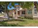 A charming single-Gathering home with lush green lawn, mature trees, and inviting front porch at 1470 St Joseph St, Overton, NV 89040