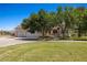 Charming home featuring a large front lawn, mature trees, and a three-car garage at 1470 St Joseph St, Overton, NV 89040