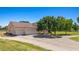 Beautiful home with a large front lawn, mature trees, long driveway, and three-car garage at 1470 St Joseph St, Overton, NV 89040