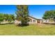 Charming home with covered porch, large trees, and well-maintained lawn at 1470 St Joseph St, Overton, NV 89040