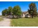 Gorgeous single-Gathering home with a long driveway, lush green lawn, and mature trees at 1470 St Joseph St, Overton, NV 89040