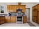 Kitchen with tile floor, granite countertops, stainless-steel appliances and oak cabinets at 1470 St Joseph St, Overton, NV 89040