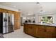Open kitchen with stainless steel refrigerator, granite countertops, and oak cabinets at 1470 St Joseph St, Overton, NV 89040