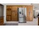 Kitchen featuring stainless steel fridge, oak cabinets, and tile flooring at 1470 St Joseph St, Overton, NV 89040