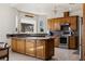 Bright kitchen with granite countertops, wood cabinets, and stainless steel appliances at 1470 St Joseph St, Overton, NV 89040