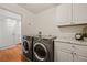 Laundry room featuring new appliances, cabinets, and a white door at 1470 St Joseph St, Overton, NV 89040