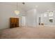 Open concept living room featuring neutral carpet, chandelier, and front door view at 1470 St Joseph St, Overton, NV 89040