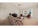 Bright living room features large windows, piano, neutral carpet, and comfortable seating at 1470 St Joseph St, Overton, NV 89040