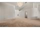 Open-plan living room with neutral carpet, recessed lighting, curved walls, and a chandelier at 1470 St Joseph St, Overton, NV 89040