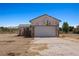 A detached outbuilding with garage door and additional storage shed on a spacious lot at 1470 St Joseph St, Overton, NV 89040