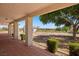 Inviting covered porch with tile flooring, views of the expansive yard and mature trees at 1470 St Joseph St, Overton, NV 89040