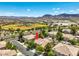 A residential neighborhood with a baseball field in the background, mountain views, and well-maintained landscaping at 1605 Colloquium Dr, Henderson, NV 89014