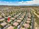 An aerial shot showcases a community with uniform homes, tree-lined streets, and a serene suburban setting at 1605 Colloquium Dr, Henderson, NV 89014