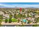 Bird's-eye view of a residential neighborhood with a community pool and lush landscaping, mountains in the background at 1605 Colloquium Dr, Henderson, NV 89014