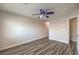 Bright bedroom with wood-look floors, ceiling fan and convenient access to the hallway at 1605 Colloquium Dr, Henderson, NV 89014