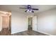 Bedroom with ceiling fan and access to a bathroom and hall at 1605 Colloquium Dr, Henderson, NV 89014