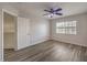Light-filled bedroom featuring wood-look floors and ceiling fan and window at 1605 Colloquium Dr, Henderson, NV 89014