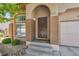Close-up of the front entrance featuring an arched entryway and a neatly landscaped walkway at 1605 Colloquium Dr, Henderson, NV 89014