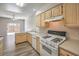 Updated kitchen featuring appliances, laminate countertops, and hardwood flooring at 1605 Colloquium Dr, Henderson, NV 89014