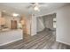 Open concept living room with modern flooring and a view into the kitchen area at 1605 Colloquium Dr, Henderson, NV 89014