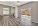 Living room showcasing a fireplace, laminate flooring, and sliding glass doors to a patio at 1605 Colloquium Dr, Henderson, NV 89014