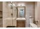 Modern bathroom featuring a sleek vanity, tiled shower with glass door, and contemporary fixtures at 1793 Clear River Falls Ln, Henderson, NV 89012