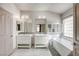 This bathroom features double sinks, a bathtub, and modern fixtures at 1793 Clear River Falls Ln, Henderson, NV 89012