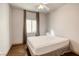 This bedroom features hardwood floors, a ceiling fan, and natural light from the window at 1793 Clear River Falls Ln, Henderson, NV 89012