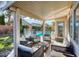 Cozy covered patio features wicker seating overlooking the sparkling fenced in pool and landscaped backyard at 1793 Clear River Falls Ln, Henderson, NV 89012