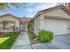 Inviting single story home with a well-manicured lawn and a welcoming entrance way at 1793 Clear River Falls Ln, Henderson, NV 89012