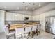 Bright kitchen featuring a large island with seating, modern appliances, and white cabinetry at 1793 Clear River Falls Ln, Henderson, NV 89012