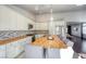 Kitchen with island, wooden countertop, stainless steel appliances and seamlessly connects to the living room at 1793 Clear River Falls Ln, Henderson, NV 89012
