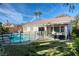 Backyard view showcasing a fenced in in-ground pool, spa, covered patio, and well-manicured lawn at 1793 Clear River Falls Ln, Henderson, NV 89012