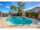 Gorgeous in-ground pool features a spa, well-maintained landscaping, and clear blue skies at 1793 Clear River Falls Ln, Henderson, NV 89012