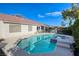 A backyard view showcasing the in-ground pool, spa, solar panels and patio of this home at 1793 Clear River Falls Ln, Henderson, NV 89012