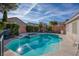 Beautiful backyard features a sparkling in-ground pool with a spa and lush, mature landscaping at 1793 Clear River Falls Ln, Henderson, NV 89012