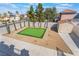 Backyard features a putting green, desert landscaping, shed, and privacy fencing for outdoor fun at 1808 Quartz Landing Ave, Las Vegas, NV 89183