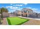 Spacious backyard with putting green, patio space, and mature trees provides ample space for entertainment at 1808 Quartz Landing Ave, Las Vegas, NV 89183