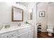 Bright bathroom with a stylish wood-framed mirror, modern fixtures, and storage at 1808 Quartz Landing Ave, Las Vegas, NV 89183