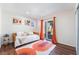 Bright bedroom featuring hardwood floors, a sliding glass door, neutral paint, and modern decor at 1808 Quartz Landing Ave, Las Vegas, NV 89183