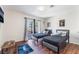Bright bedroom featuring two twin beds, wood floors, and a sliding glass door leading to the outside at 1808 Quartz Landing Ave, Las Vegas, NV 89183