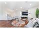 Bright and airy living room featuring a fireplace, modern furniture, and beautiful hardwood floors at 1808 Quartz Landing Ave, Las Vegas, NV 89183