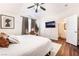 Comfortable main bedroom with wood floors, a ceiling fan, an ensuite bathroom, and natural light at 1808 Quartz Landing Ave, Las Vegas, NV 89183