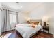 Bright main bedroom features a modern color palette, a large window, and wood-look flooring at 1808 Quartz Landing Ave, Las Vegas, NV 89183
