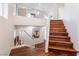 Elegant staircase with hardwood steps, white railings, and abundant natural light from nearby windows at 1808 Quartz Landing Ave, Las Vegas, NV 89183