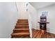 Wood staircase with an NBA Jam arcade game on the upper floor landing near a window at 1808 Quartz Landing Ave, Las Vegas, NV 89183