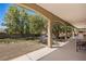 Expansive backyard with rock landscaping, shade trees, and covered patio at 1981 Trophy Elk Ave, Logandale, NV 89021