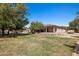Spacious backyard featuring a lawn, trees, and a view of the home with a covered patio at 1981 Trophy Elk Ave, Logandale, NV 89021